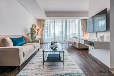 a living room with a couch and a table at Cozy Studio at The Matrix Sports City by Deluxe Holiday Homes in Dubai