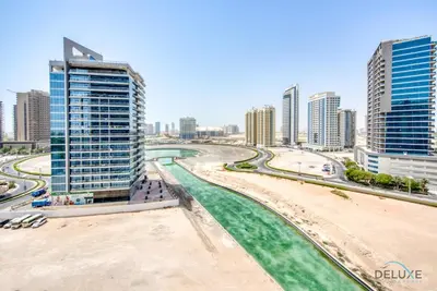 a view of a city with tall buildings and a beach at Cozy Studio at The Matrix Sports City by Deluxe Holiday Homes in Dubai