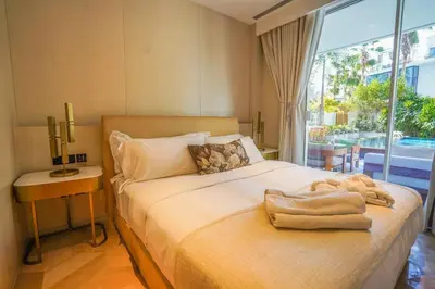a bedroom with a bed and a large window at Private Pool Apt. Five Palm Jumeirah up to 6guest in Dubai