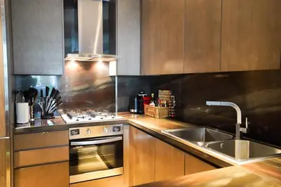 a kitchen with a sink and a stove at Private Pool Apt. Five Palm Jumeirah up to 6guest in Dubai