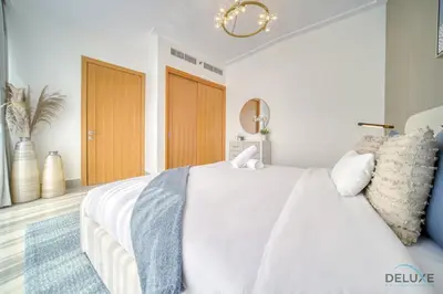 a bedroom with a large white bed with pillows at Extravagant 1BR at Opera Grand Downtown Dubai by Deluxe Holiday Homes in Dubai