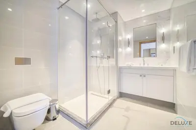 a bathroom with a shower and a toilet and a sink at Extravagant 1BR at Opera Grand Downtown Dubai by Deluxe Holiday Homes in Dubai