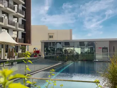 an external view of a building with a swimming pool at Elite LUX Holiday Homes - Modern Style Studio Superior Facilities in Arjan Dubai in Dubai