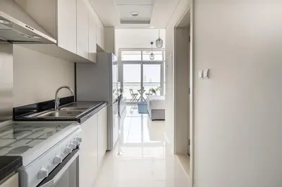 a kitchen with a sink and a counter top at Frank Porter - Carson Tower C in Dubai