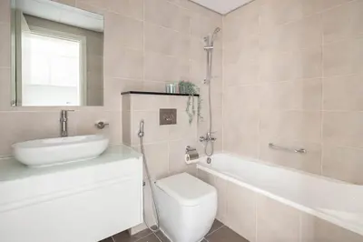 a bathroom with a toilet and a sink and a tub at Frank Porter - Carson Tower C in Dubai