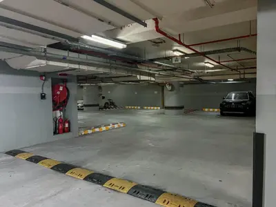 a parking garage with a car parked in it at Cosmos Living Modern Studio Near Dubai Marina in Dubai