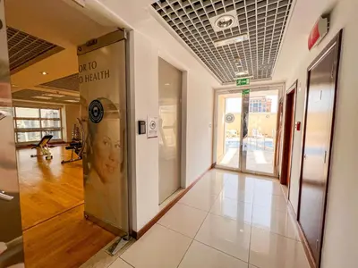 a hallway of a building with a elevator at Cosmos Living Modern Studio Near Dubai Marina in Dubai