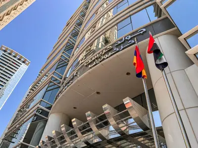 a building with three flags in front of it at Cosmos Living Modern Studio Near Dubai Marina in Dubai