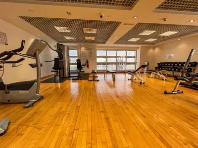 a gym with treadmills and exercise equipment in a room at Cosmos Living Modern Studio Near Dubai Marina in Dubai