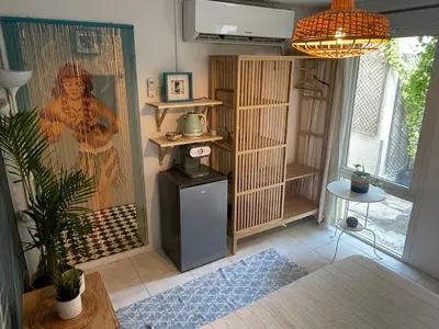 a living room with a painting on the wall at Tropicana Guestroom 7 min walk from the beach in Dubai