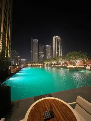 a large pool of water with a city at night at Address Dubai Mall Fashion Avenue Full Burj Khalifa views Studio in Dubai