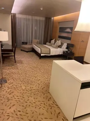 a large hotel room with a bed and a desk at Address Dubai Mall Fashion Avenue Full Burj Khalifa views Studio in Dubai