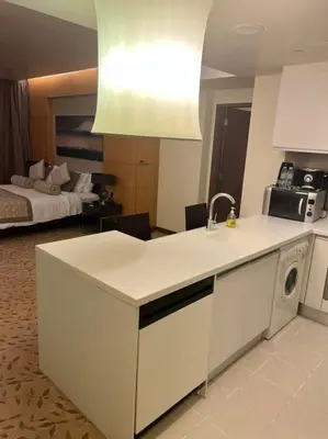 a kitchen with a sink and a stove top oven at Address Dubai Mall Fashion Avenue Full Burj Khalifa views Studio in Dubai