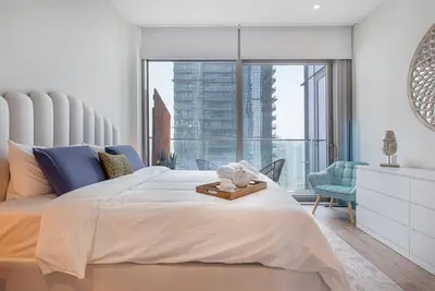a bedroom with a large bed and a large window at Luxury apartment 38th floor Dubai MarinaEXPO OFFER in Dubai