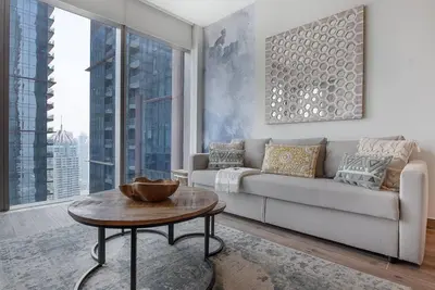 a living room with a couch and a table at Luxury apartment 38th floor Dubai MarinaEXPO OFFER in Dubai