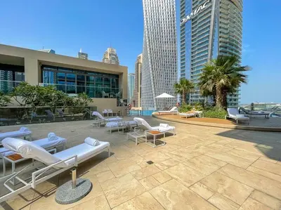 a patio with lounge chairs and tables and buildings at Luxury apartment 38th floor Dubai MarinaEXPO OFFER in Dubai