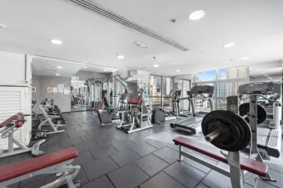 a gym with treadmills and machines in a building at Classic Studio With Dubai Marina View in Dubai