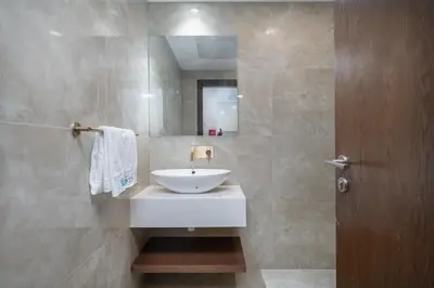 a bathroom with a white sink and a mirror at Elegant 1br in Zaya Hameni in Dubai