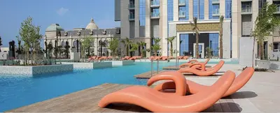 a swimming pool with orange inflatables in front of a building at Noora Tower I Spacious 3BDR Apartment and maid room with Burj Khalifa View in Dubai