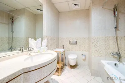 a bathroom with a tub and a sink and a toilet at Bright 1BR at Sulafa Tower Dubai Marina by Deluxe Holiday Homes in Dubai