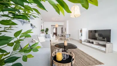 a living room with a couch and a table at Hashtag Holiday Home - Luxury 2BDR Apartment on The Palm Azure Residences in Dubai