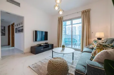 a living room with a couch and a tv at 2 Bedroom Apartment I Marina Diamond 4 I Close To Metro in Dubai