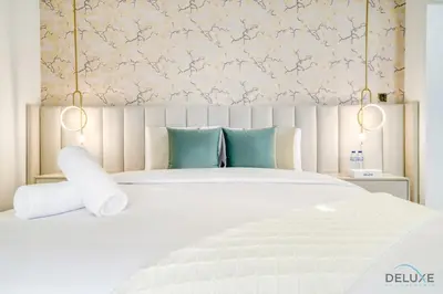 a bedroom with a large white bed with blue pillows at Signature 6BR Villa with Assistant Room and Private Pool in Frond F Palm Jumeirah by Deluxe Holiday Homes in Dubai