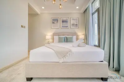a bedroom with a large white bed with a window at Signature 6BR Villa with Assistant Room and Private Pool in Frond F Palm Jumeirah by Deluxe Holiday Homes in Dubai