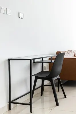 a black desk with a chair next to a bed at Amazing Marina View - Near the Beach! in Dubai