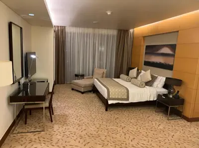 a large hotel room with a bed and a desk at Address Dubai Mall Fashion Avenue Studio 17 floor in Dubai
