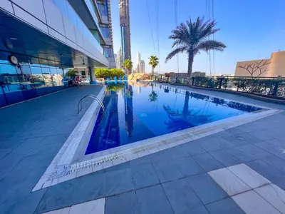 a swimming pool in the middle of a building at Exquisite, luxe 1BD Apartment, Unparalleled Sea Views, Prime Dubai Marina Location & Full Kitchen by 