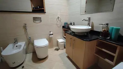 a bathroom with a sink and a toilet and a sink at Exquisite, luxe 1BD Apartment, Unparalleled Sea Views, Prime Dubai Marina Location & Full Kitchen by 