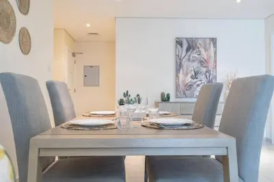 a dining room with a table and chairs at Charming Apartment in Central Dubai Marina in Dubai