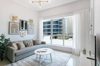 a living room with a couch and a table at Beach apartment in Dubai in Dubai