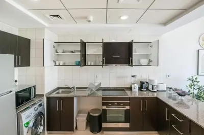 a kitchen with a sink and a dishwasher at Beach apartment in Dubai in Dubai