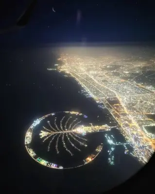 an aerial view of a city at night at Beach apartment in Dubai in Dubai