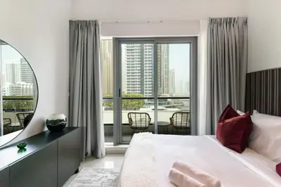 a bedroom with a large bed and a large window at Beach apartment in Dubai in Dubai