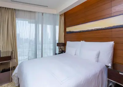a bedroom with a white bed and a window at Deluxe Stay - Address Dubai Mall -The Residence in Dubai