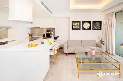a kitchen and living room with a couch and a table at Deluxe Stay - Address Dubai Mall -The Residence in Dubai
