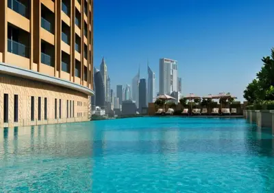 a large pool of water with a city in the background at Deluxe Stay - Address Dubai Mall -The Residence in Dubai