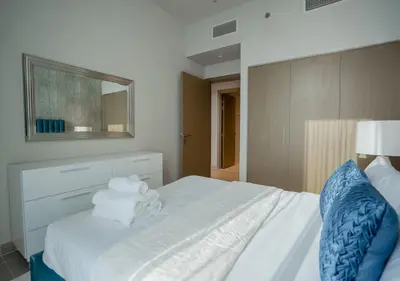 a bedroom with a white bed with towels on it at Nasma Luxury Stays - Harbour Gate Tower 1 in Dubai