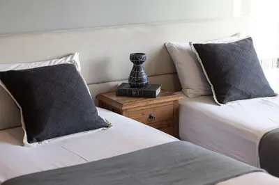 a bedroom with two beds and a lamp on a night stand at Lovely Dubai Eye & Sea View, 3 mints to beach in Dubai