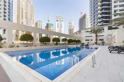 a swimming pool in a city with tall buildings at Lovely Dubai Eye & Sea View, 3 mints to beach in Dubai