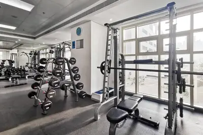 a gym with several tread machines and a window at Lovely Dubai Eye & Sea View, 3 mints to beach in Dubai