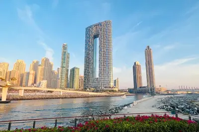a view of a city with tall buildings and a river at Livbnb - Lush 2BR Suite with Sea and Ain View in Address JBR in Dubai