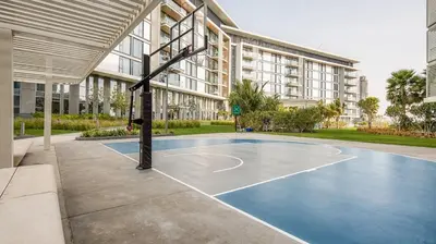 a basketball court in front of a building at Bluewaters Island 2 and 1 BDR Apart with Sea Views in Dubai