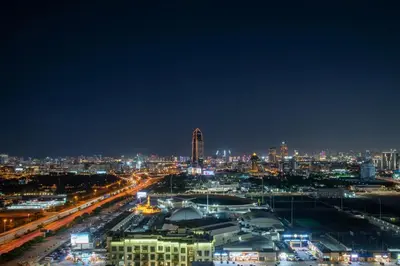 a night view of a city with lights at Frank Porter - Binghatti Avenue in Dubai
