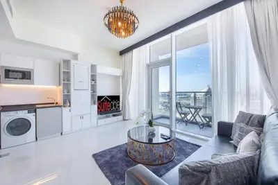 a living room with a couch and a table at Breathtaking view compact & modern spacious studio in Dubai