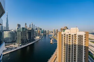 a view of a river in a city with buildings at Kasco Homes Waves Tower Business Bay in Dubai