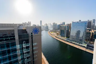 a view of a river in a city with buildings at Kasco Homes Waves Tower Business Bay in Dubai